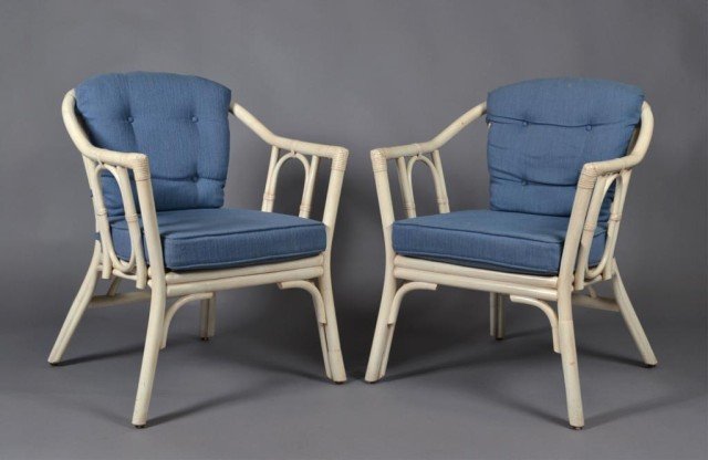 Pr. Of Rattan Arm Chairs: Rattan chairs pianted in cream with seat and back cushion upholstered in a blue fabric. 32" H x 25" W x 25" D. Circa mid 20th century. Private collection St. Clair Shores, MI.