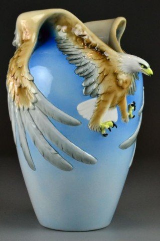 Franz Porcelain Eagle Vase: Finely moulded to depict a three dimensional eagle, it's wings wrapped around the jar, 15" H, circa 20th century.