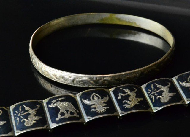 (2 Sterling Bracelets Including Siam & Mexico: To include a Siam Large sectioned braclet with etched desgns of Indian figures stamped Siam sterling, together with a sterling bangle stamped Mexico, largest is 7"L, total weight 49 grams, circa early