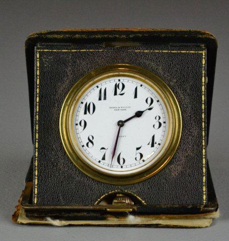 Udall & Ballou 8 Day Adjustable Clock: This Udall & Ballou New York, travel clock in a leather case, 5" H, circa early 20th century, condition the bottom piece of leather is detached, the clock appears to be in working order