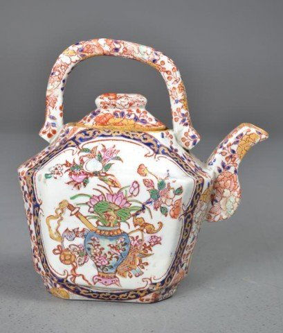 Chinese Porcelain Enameled Tea Pot: Finely painted to depict a vase on stand with lotus blossoms a bat, a jin, a butterfly, and other figures with six character mark in red under glaze, 7.125"H X 6.25"L X 3.5"W. Private collection Charl