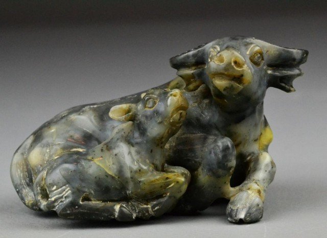 A Fine Chinese Carved Soapstone Water Buffalo: Depicting a lying buffalo and calf, the stone a grey color with fine polish, wonderfully carved, 5"L X 3'H.