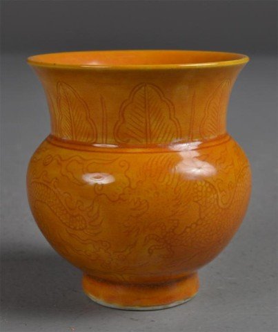 Chinese Yellow-ochre Spitoon or Vase: Spitoon-shaped vase underpainted with two dragons and leaves on neck, having a rich yellow-ochre glaze and four underglazed blue marks on bottom, 3.5" H. Private collection Rochester Hills, MI.