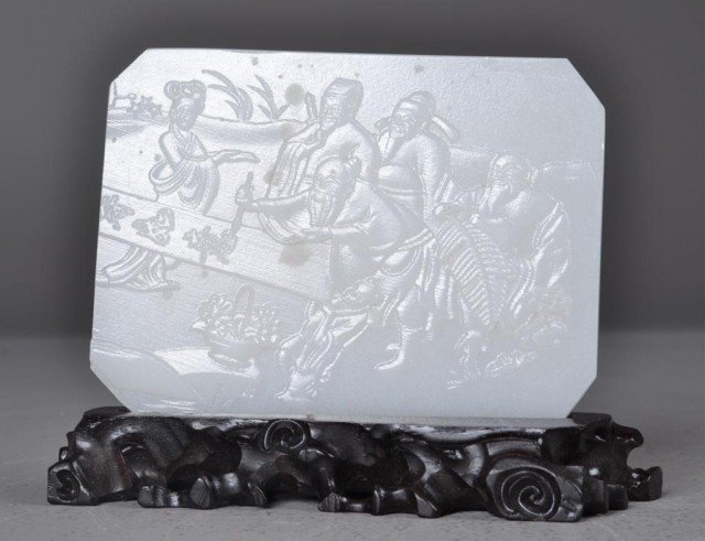 Chinese White Jadite Carved Screen with Stand: Carved rectangular white jadite screen depicting five figures observing a scribe, along with carved wood base, 5.75" L x 4" W x .25" D. Private collection Rochester Hills, MI.