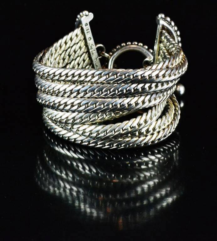 Signed Stephen Dweck Sterling Bracelet: Consisting of nine thick braided sterling silver chains mounted on beaded toggle clasp to form a bracelet, marked Stephen Dweck, 1991, sterling, 7.5" L, 164 grams, circa 20th century, excellent condit