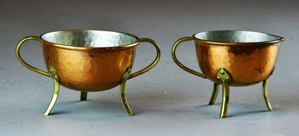 Pr. Arts & Crafts Hammered Copper Cream/Sugar: Each with tin lining, raised on curved legs and each with loop form handles, 2.25" H, circa early 20th century, good condition.