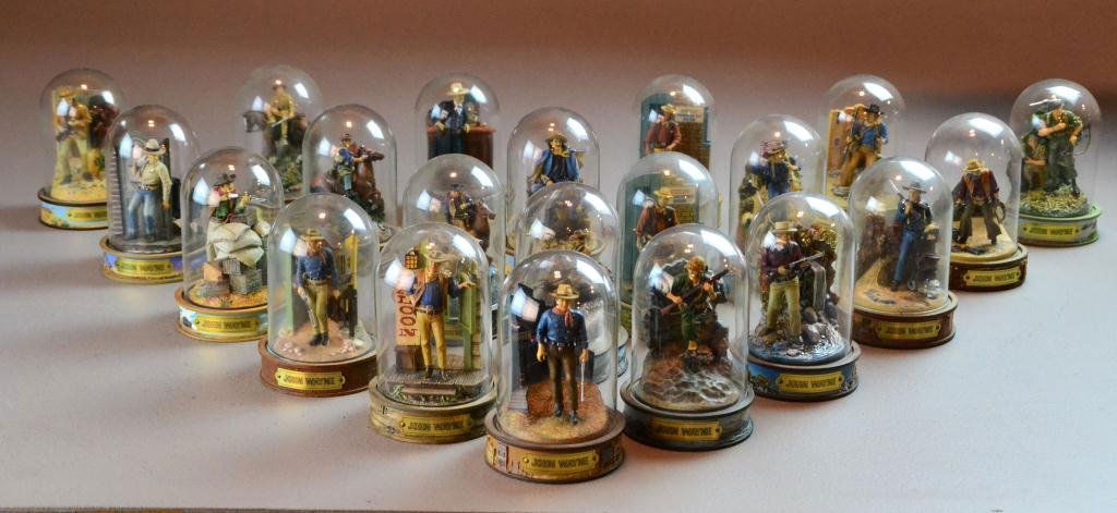 (21) John Wayne Figures in Glass Bell Jars: To include various hand-painted figures in limited editions depicting roles that the actor, all in glass belljars on decorative plinths, John Wayne, portrayed, each 6" H, "True Grit," "Stagecoach," et