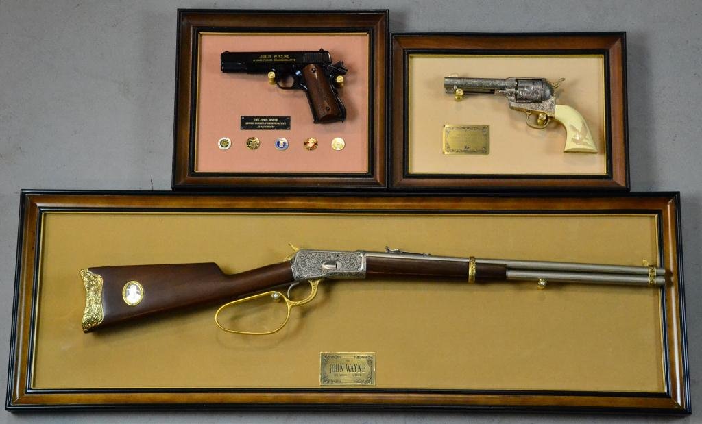 John Wayne framed 1892 Model Rifles & Pistols: To include various framed commemorative rifles and guns: .44-40 rifle in lever action, .45 single action pistol, a.45 automatic, 43" L x 14.5" H, along with framed 1990 stamp of "Stagecoach," all non 