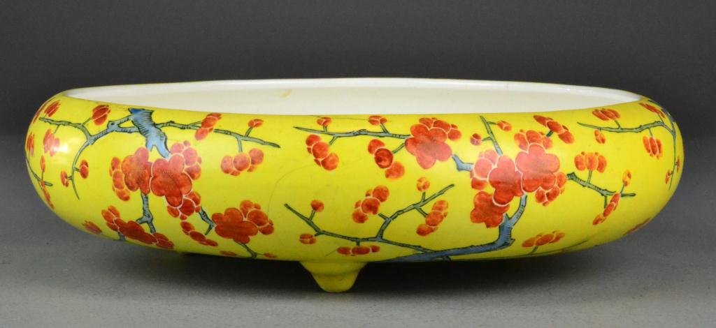 Japanese Early Nippon Porcelain Basin: Depicting overall orange blossoms with branches on bright yellow imperial ground, low curved bowl raised on three feet, with white glazed interior, circa early 20th century, marked in iron red on bott