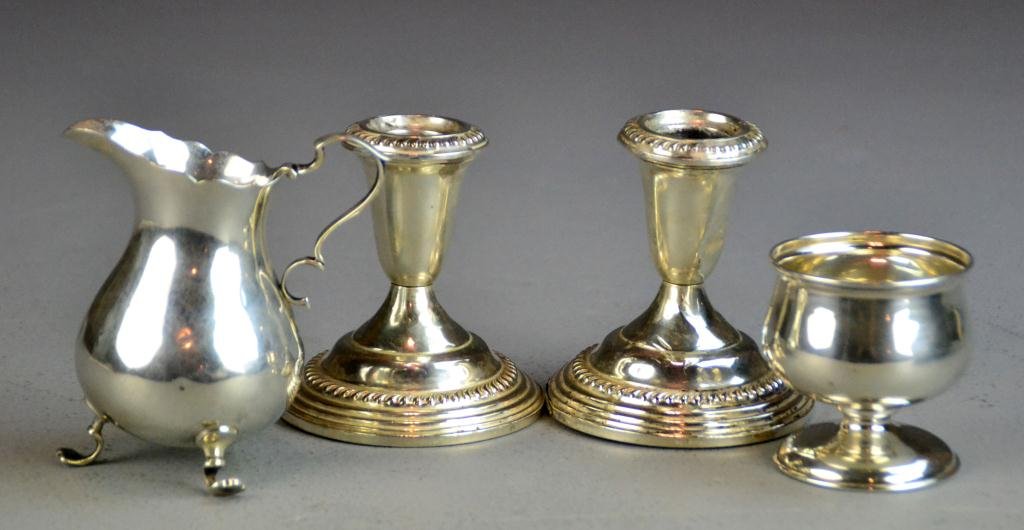 (4) Pcs. Sterling Silver: To include an International Federal Style cream jug, a Federal Style master salt cellar together with a pair of Empire weighted candlesticks, tallest is 3.5" H, total weight 650 grams, condition: crea