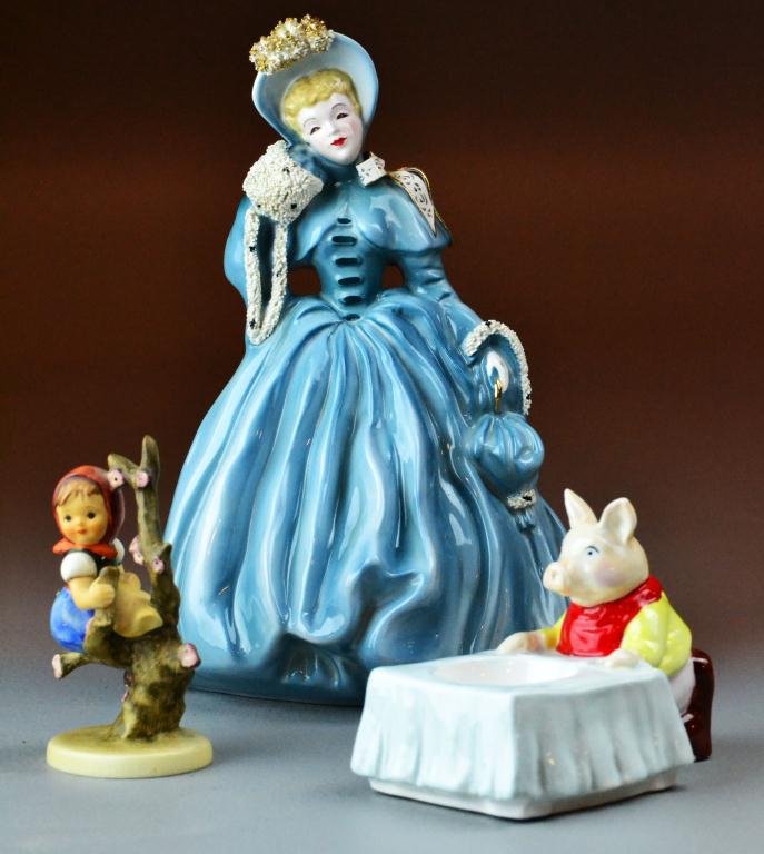 (3) Pcs. Porcelain Including Tiffany & Hummel: Consisting of Staffordshire egg cup with piggie made for Tiffany & Co, a Hummel figurine of girl climbing tree along with Victorian Pasadena figurine in blue, circa 20th century, pig has hairline crac