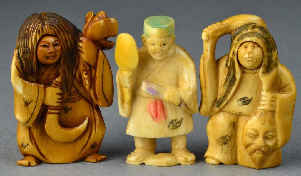 (3) Japanese Carved Ivory Netsuke: To include two examples depicting witchs together with a third example of a villager, two pieces with inscription to bottom, tallest is 2"H. important Traverse City Michigan Collection.