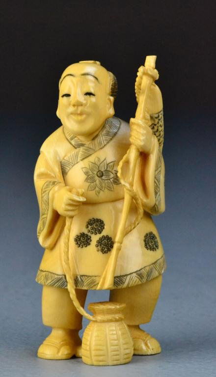 Japanese Carved Ivory Okimono Of A Fisherman: Finely carved to depict fisheman with basket and fish, with inked and dyed elements, bareing two character mark on bottom of right foot, 4"H, circa Meji period. Important Traverse City Michigan Collec