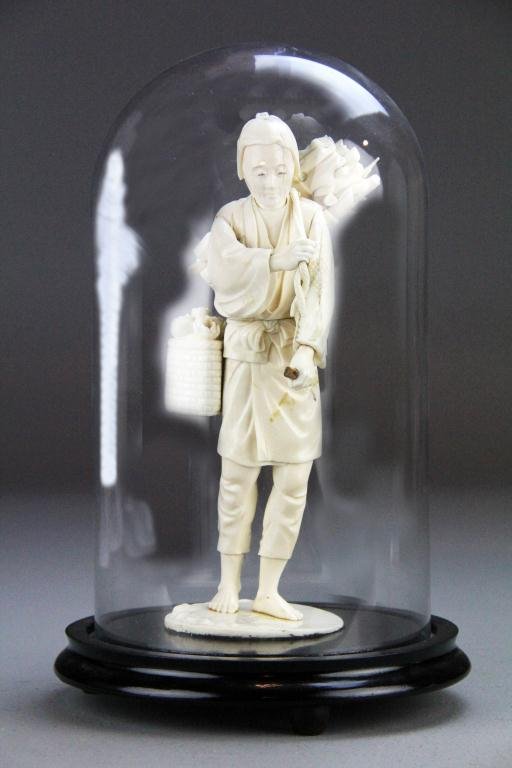Japanese Carved Ivory Okimono: Finely carved to depict a villager with bundle of sticks and basket of flowers, now raised on hardwood stand under display globe, 12"H including stand, circa late 19th/early 20th century. Condition: B