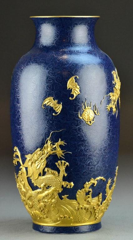 A Fine Chinese Imperial Gilt Dragon Vase: Heavily carved and gilded to depict dragons chasing a flaming pearl amongst bats, all against a blue graviata ground depicting clouds, the interior and footrim glazed turquoise, with sealmark Great Qi