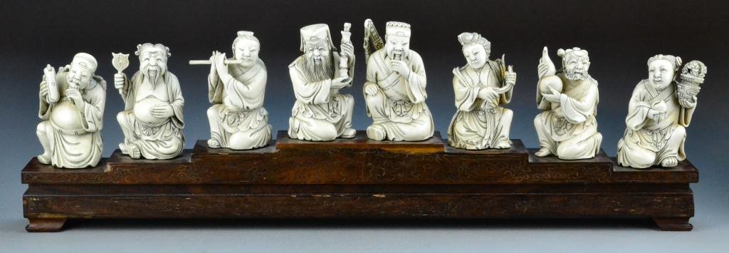 Chinese Qing Carved Ivory Eight Immortals: Finely carved with incredible attention to detail from the tip of the ivory tusk to depict the eight immortal, raised on silver inlay rosewood stand, one piece was removed from stand for inspection an