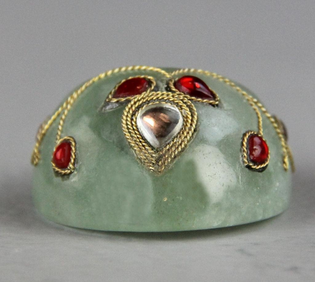 Chinese Qing Moghul Style Jade Archers Ring: Finely carved in Islamic collar form, with gold metal thread and semi precious stones, measures 2"L X 1.5"W, inside diameter .75"D, circa 20th century. Property of a Houston Texas gentleman.