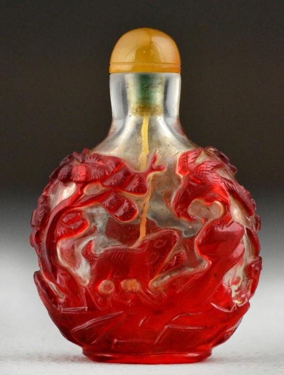 Chinese Qing Peking Glass Snuff Bottle: Red overlay glass on a clear ground to depict a tiger and bat on one side and a squirrel and hawk on reverse forming a rebus, 3"H, circa late 19th/early 20th century. property of a gentleman.