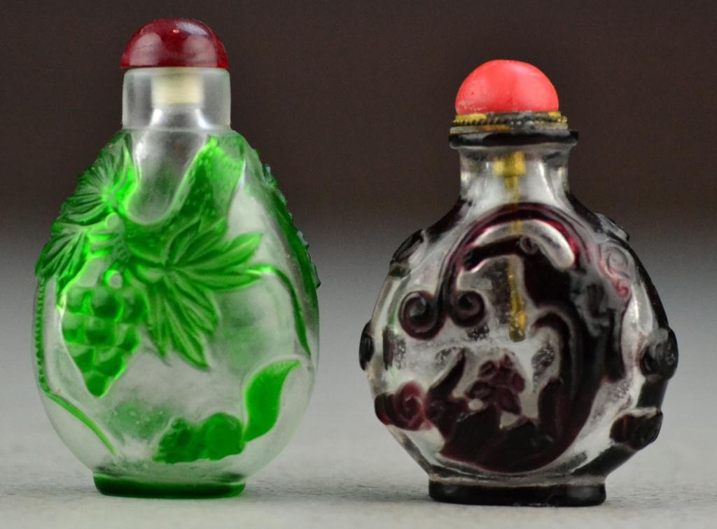(2) Chinese Peking Glass Snuff Bottles: One deicting squirrel under grabe vine, the othe depicting chi-long, largest is 3"H. Property of a Holly MI Gentleman.