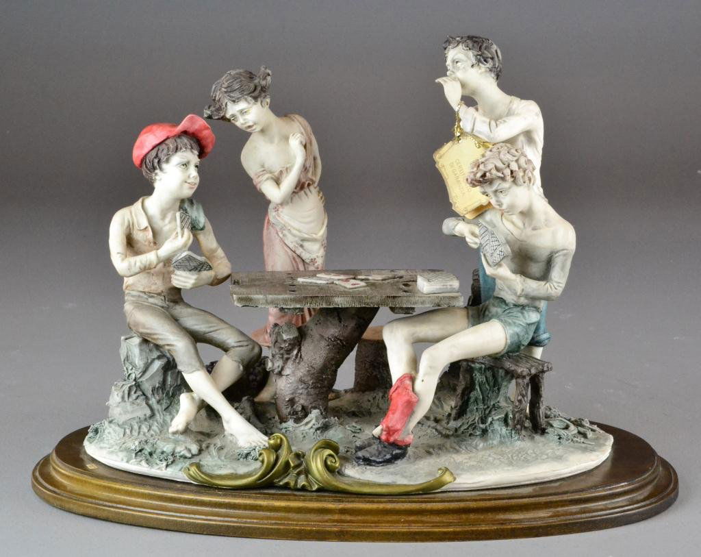 "Playing Cards" Capodimonte-style Composite: Figural grouping of young people playing cards by Guiseppe Armani, marked on side GA, raised on oval wooden plinth, Guiseppe Armani, good condition, 11" H x 16" L x 9.5" W, Private collection Warren,
