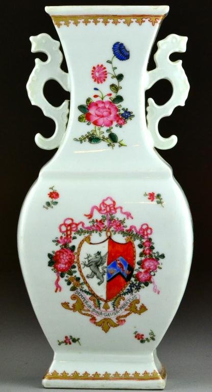 Chinese Famille Rose Export Vase: With two chilong handles, finely decorated with lion and flag shields amid swag floral designs, and ribbon that reads "Semper.In.Bona.Gausa.Paratus," and gilt highlights throughout. 11 & 1/8" H x 5" W