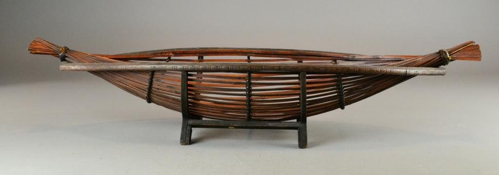 Malaysian Fruit Basket: Consisting of a woven basket made of bamboo with egg & dart decoration to rim and having attached wooden stand, 8" H x 36" L x 12" W, circa 20th century, good condition. Private collection Grand Rapid