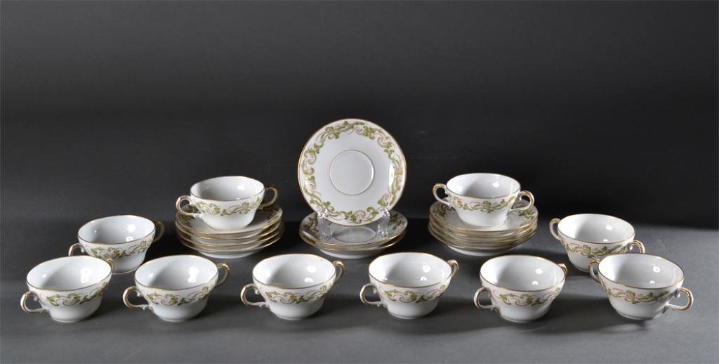 (21) Pieces Limoges Bullion Cups & Saucers: Marked for Theodore Haviland Limoges France, retailed by Burley & Co. Chicago. Includes ten bullion cups and eleven saucers, decorated in mint green and gilt floral and scroll decorations. Circa early
