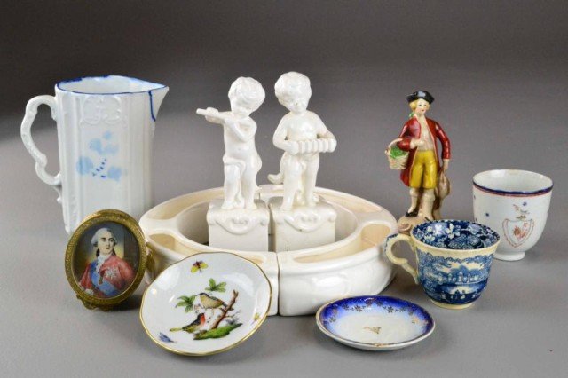 (10) Pieces Various Porcelain And Hand Colored Tri: To include a white porcelain centerpiece decorated with puti figures, a Mason's Vista blue transferware demitasse cup, a armoral demitasse cup with shield, Delft style blue and white porcelain pitcher