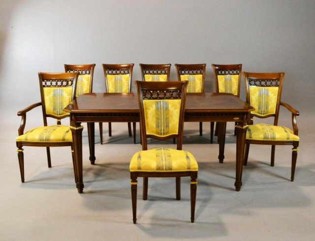 Spectacular (9) Piece Italian Dining Set by Cantalu: To include a dining table, six side chairs, and two arm chairs, in the Regency taste, in finely figured walnut with gilt elements, the chairs upholstered in relief decorated silk depicting scrolling f