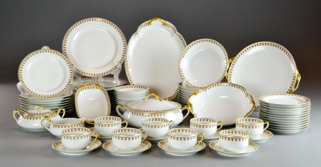 (71)Pieces Haviland Limoges Porcelain Tableware: Gold trimmed dinnerware with chased green Fleur de Lis decoration with a touch of red, consisting of 9 plates, 9 bowls, 9 salads, 8 saucers, 8 cups, 9 dessert, 12 bread, 1 veg, 1 small veg, cream/suga
