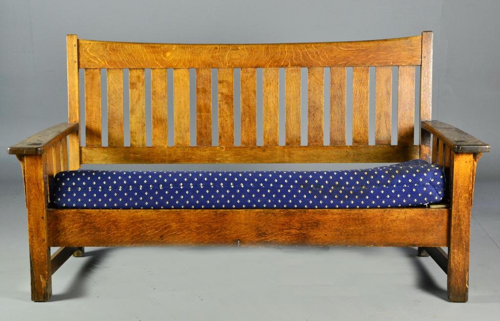 Limbert Arts and Crafts Oak Settee: Having overall slat design now fitted with blue upholstered cushion, signed under arm Grand Rapids and Holland Michigan, 39" H x 69.5" L x 27.5" W, circa early 20th century, having losses to two front