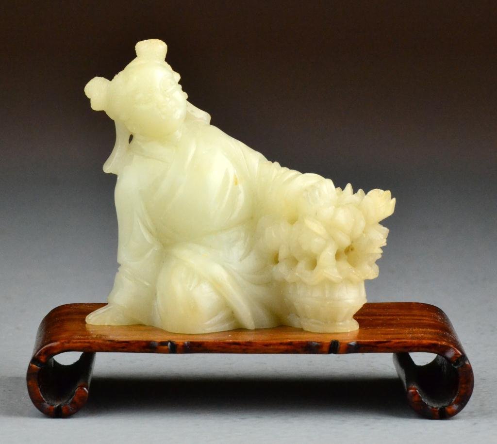 A Fine Chinese Qing Soapstone Figure: Finely carved in white soapstone depicting a seated beauty depicting a basket of flowers, signed with 2 or 3 charter marked underside, the carving exhibits wonderful detail and fine polish, raised on 