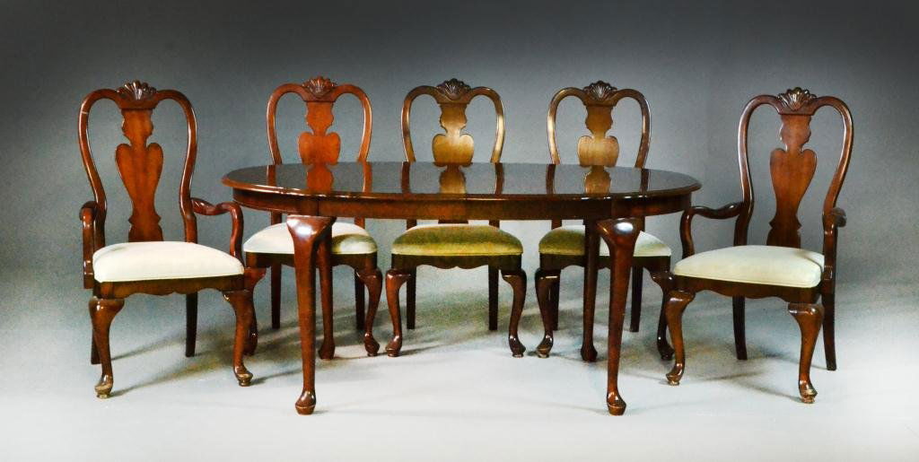 (6) Piece Queen Anne Style Mahogany Dining Set: Labeled for Universal Furniture Company of North Carolina having two arm chairs and three side chairs each having carved splats together with an oval dining table, having one leaf, all raised on Queen