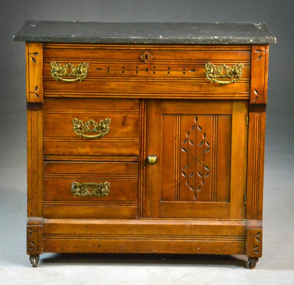 Eastlake Commode with Black Marble Top: Marble top above one drawer with eschutcheon over two doors,, circa late 19th-early 20th century, 27" H x 30" W x 15.5" D, gallery missing to top. Property of David and Carol Walker, Sterling Heights,