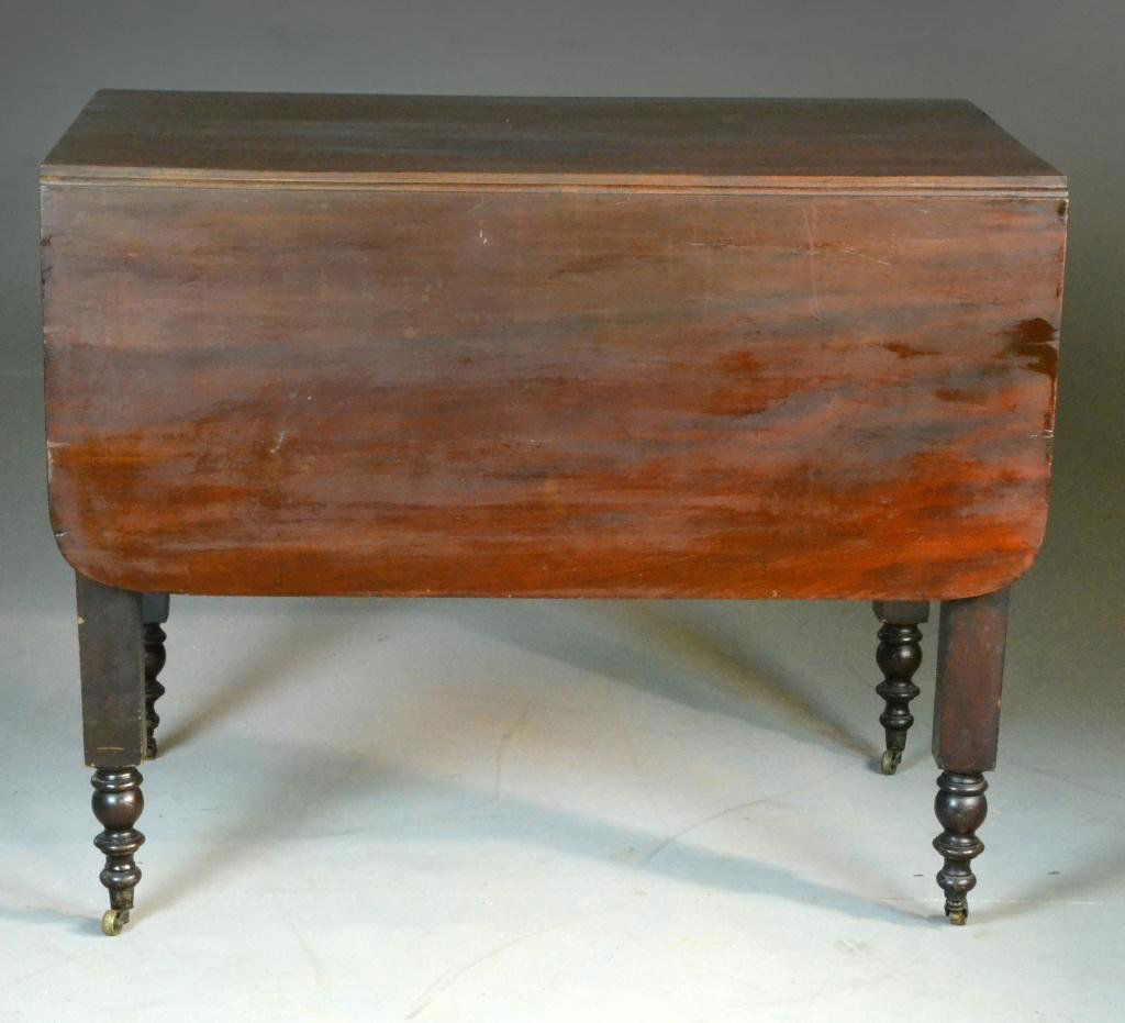 Antique Walnut Drop Leaf Table: Walnut table raised on turned square legs, 29" H x 36" L x 17" drop leaf, circa early 20th century, wear to top. Property of David and Carol Walker, Sterling Heights, Michigan.