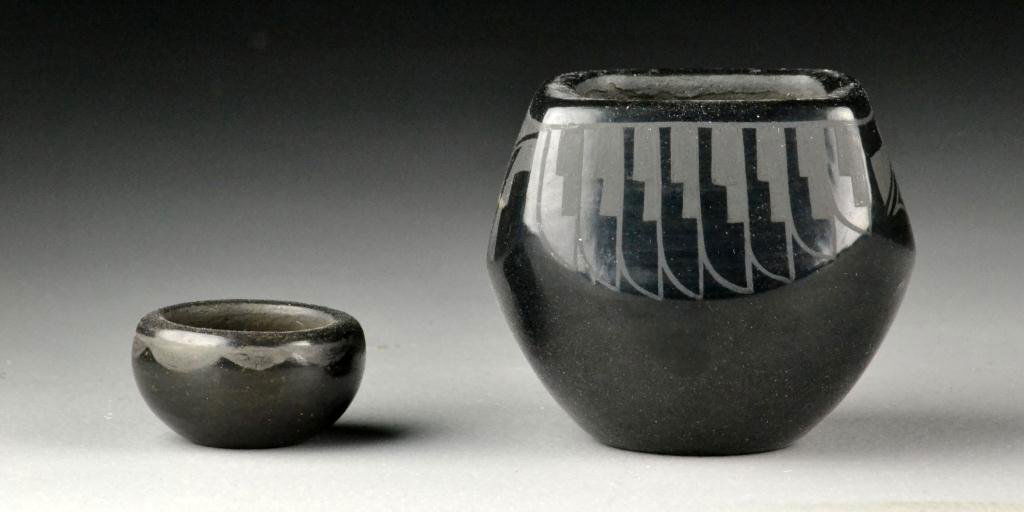 (2) San Ildefonso Blackware Pottery Vessels: To include a larger example signed by Yolanda Valarde, finely etched in geometric designs against a polished black ground, together with a smaller example with etched swag decoration against a polishe