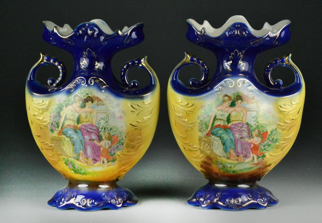 Pair of Victoriaware Ironstone Vases: Depicting two beauties and a musician angel on both front and reverse, cobalt scroll rim and pedestal foot with gilt decoration, marked Victoriaware Ironston to bottom in blue, 13.5" H x 10" W, circa 