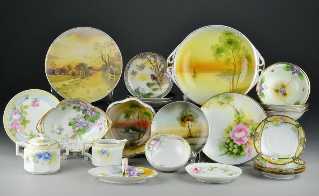 (22) Pieces Nippon And Japanese Hand Painted Porc: To include scenic plates, creamer and sugar, and other decorative hand painted pieces, some with green mark. Largest is 8" D, circa early 20th century. Property Of A Fort Gratiot, Michigan