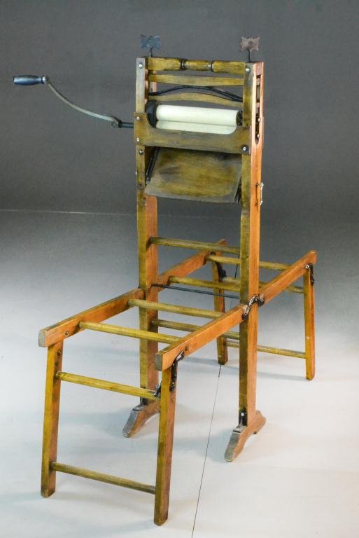 Wooden Laundry Wringer on Wooden Stand: Cast iron and wood, folding stand supported on shoe feet, 48" H x 14.5" W x 11" D, circa late 19th-early 20th century, refinished surface, rollers have some cracking. Estate of Cecelia Wolfe-Penny, Fl