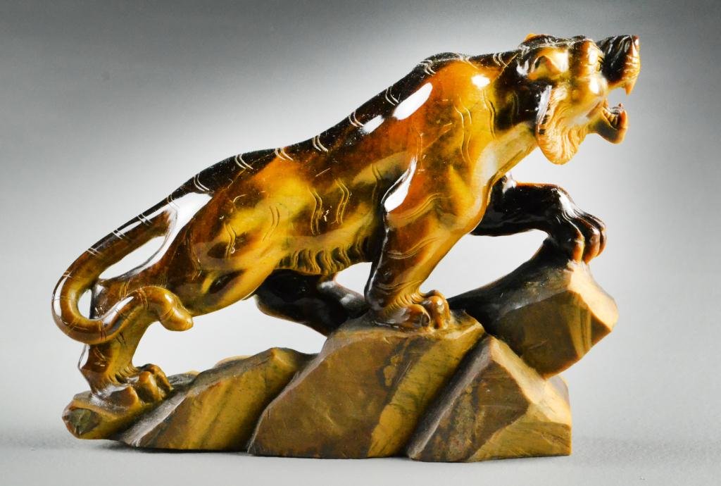 Chinese Cat's Eye Stone Tiger: Finely carved to depict a tiger on the prowl atop a rocky outcrop, the stone with fine polish, 5"H X 8"L, circa early 20th century or earlier. Property of a Royal Oak, Michigan Gentleman.