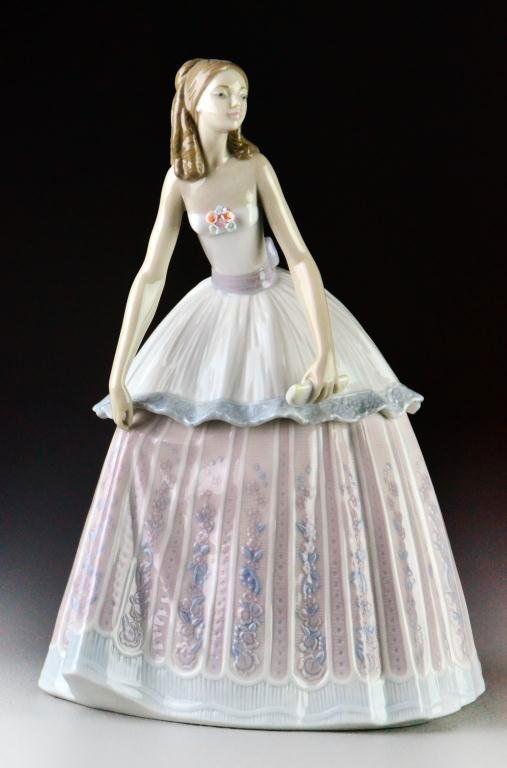Lladro Porcelain Figurine "Waiting to Dance": "Llegada a La Fiesta" #5858 depicting a young lady dressed in a full ball gown holding an evening bag in her hand, 9.5" H, excellent condition in original box. Estate of Eugenia Sager, Plymouth, Michi