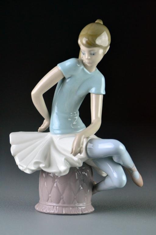 Lladro Porcelain Figurine "Julia": #1361 Depicting a seated ballerina, dated 1993 with blue mark to boom, 9" H, excellent condition. Estate of Eugenia Sager, Plymouth, Michigan.