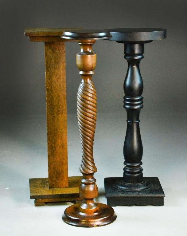 (3) American Wood Plant Stands: To include and example in oak with square top pedestal and rectangular shaft, a turned walnut example together with an ebonized wood example, largest is 36"H, all circa late 19th-early20th century.
