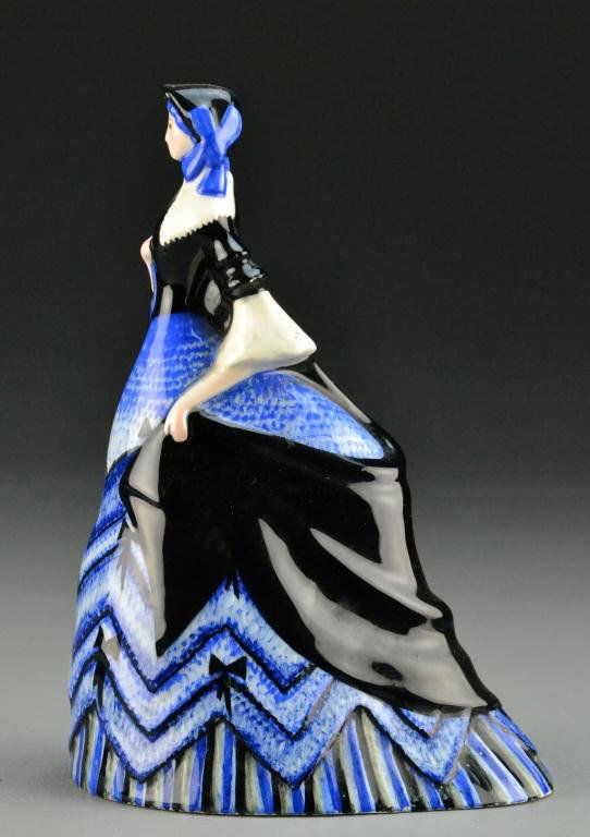 Lenci Porcelain Female Figurine: Depicting Victorian lady in blue and black dress, 8.5" H, marked Lenci to bottom, circa 20th century, minor chip to front of hat, otherwise good condition. Property of Marine City, Michigan lady.