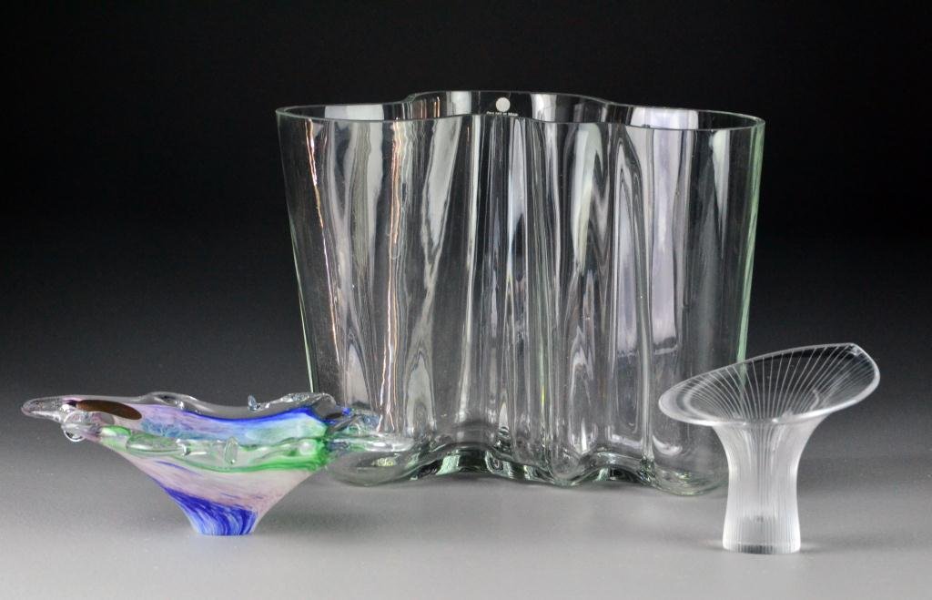 (3) Art Glass Items: To include a Murano glass multi-colored hand-blown dish, a curviliniar clear glass vase from Findland along with a beautiful Italian petal-shaped vase with cut striations and signed Tapio Wirkkala, It