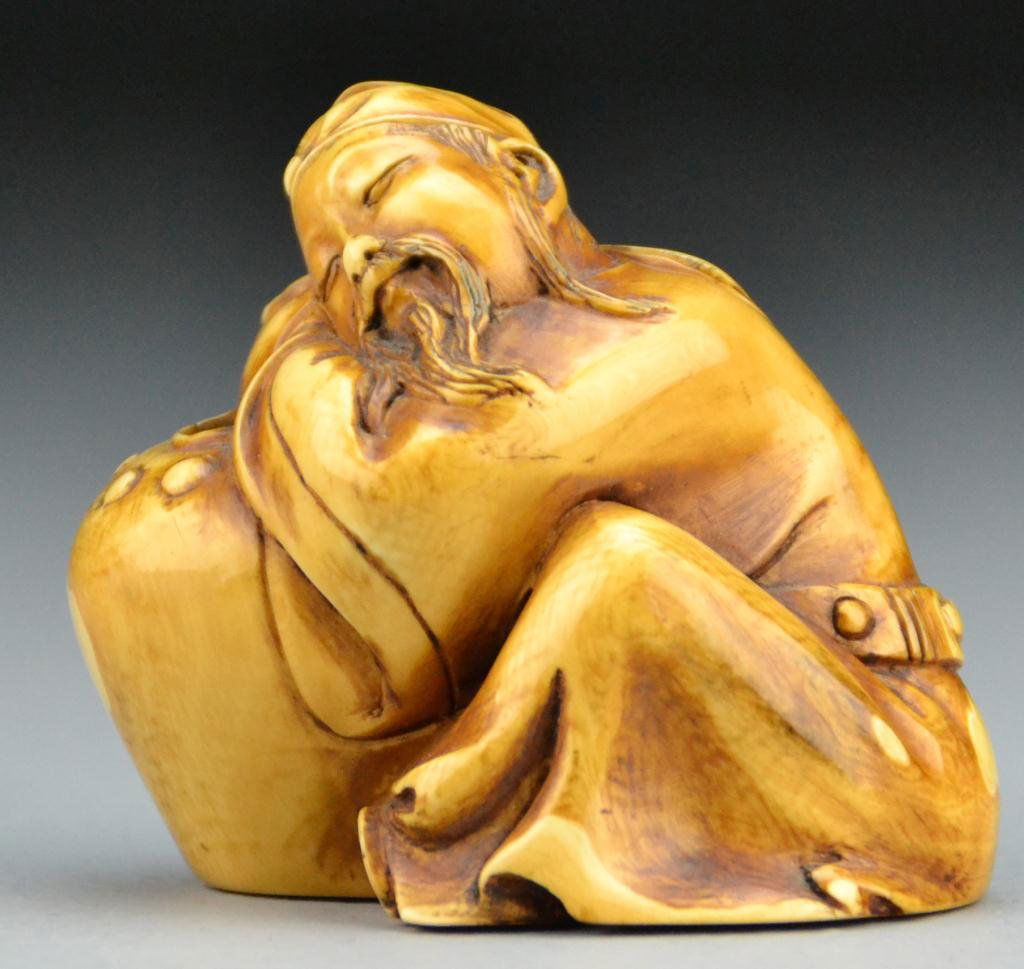 Chinese Qing Carved Ivory Sleeping Figure: Finely carved and tea stained to depict an elder sleeping on a large vase, with four character mark within a square to bottom, 2.75"H, circa early 20th century. Important Grosse Pointe Shores Michigan