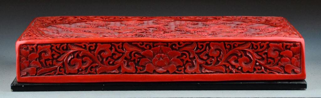 Chinese Qing Carved Cinnabar Box & Cover: Finely carved and lacquered to depict two dragons chasing the flaming pearl, 2.75"H X 15.25"L X 11.25"W, circa 19th/20th century. Important West Bloomfield Michigan Collection.