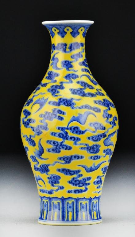 Chinese Blue & Yellow Porcelain Vase: Finely painted to depict bats amidst ruyi clouds over a yellow ground, the base bearing Qianlong seal mark in underglaze blue, 7.75"H. Private collection Rochester Hills Michigan.