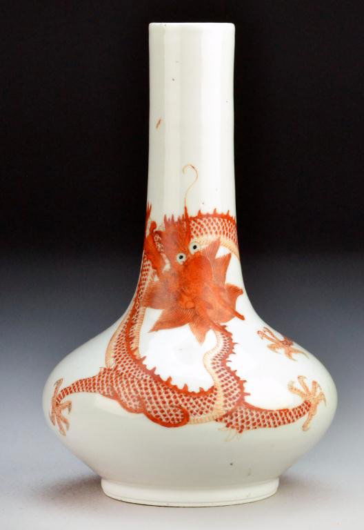 Chinese Qing White & Iron Red Porcelain Vase: To depict in iron red a five clawed dragon and a phoenix chasing a flaming pearl against a white ground, apparently unsigned, 8.25"H, circa late 19th/early20th century. Important Grosse Pointe Shores