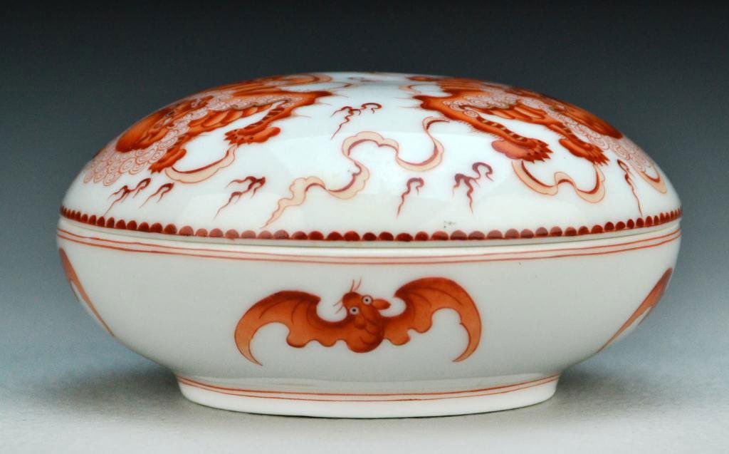 Chinese Iron Red Porcelain Ink Box: Finely painted to depict foo lions admidst ruyi clouds, the body painted with bats, raised on short foot ring, the base bearing four character mark in underglaze red, mark translates to, "Made in the